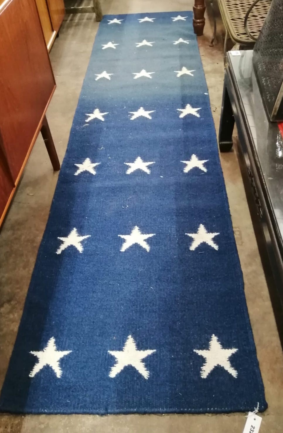 A contemporary wool runner with star motifs, 300 x 76cm *Please note the sale commences at 9am.